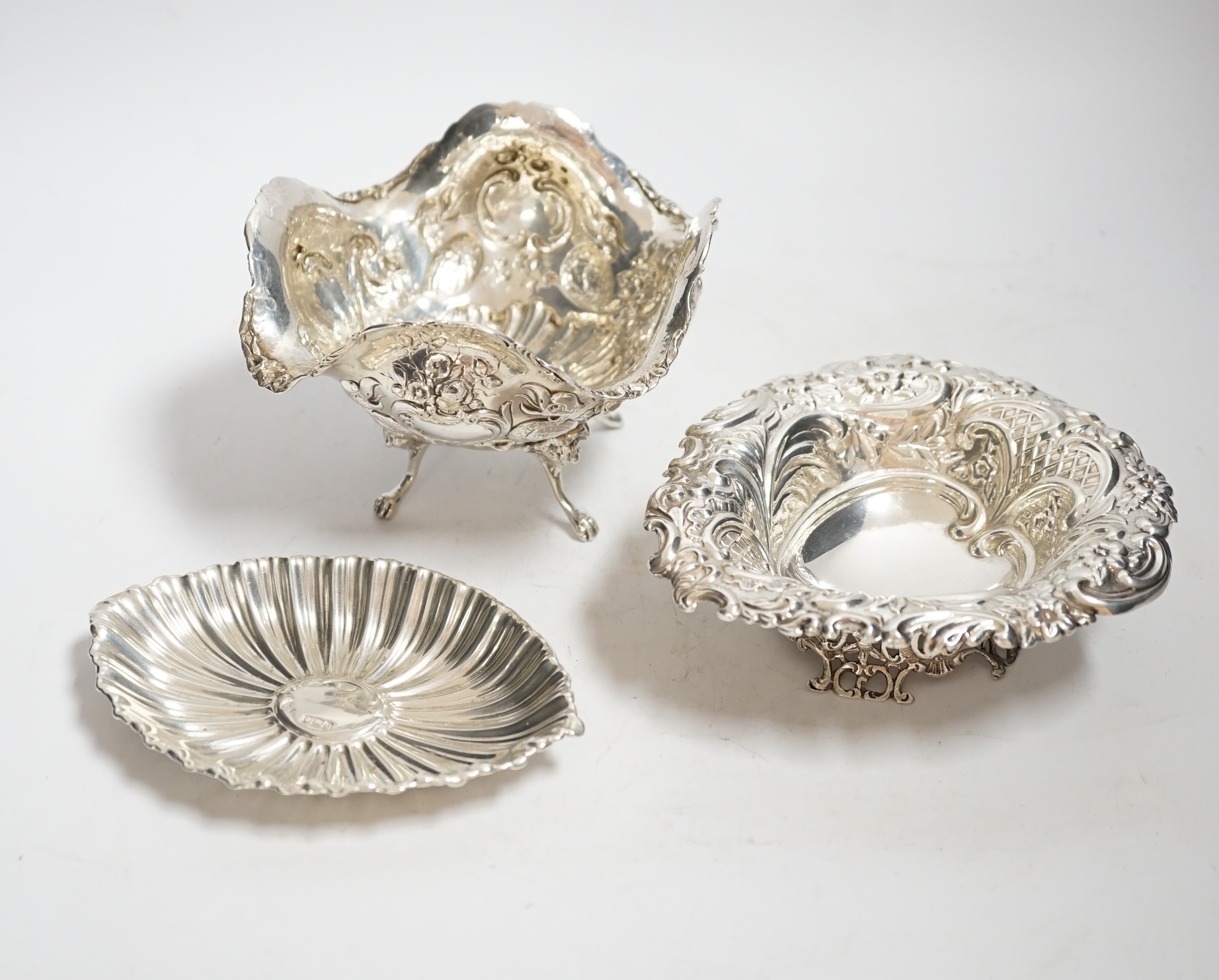 A late Victorian repousse silver heart shaped dish, I.S. Greenburg & Co, Birmingham, 1894, 14.3cm, a small silver dish and Hanau white metal bowl, 12.1oz.